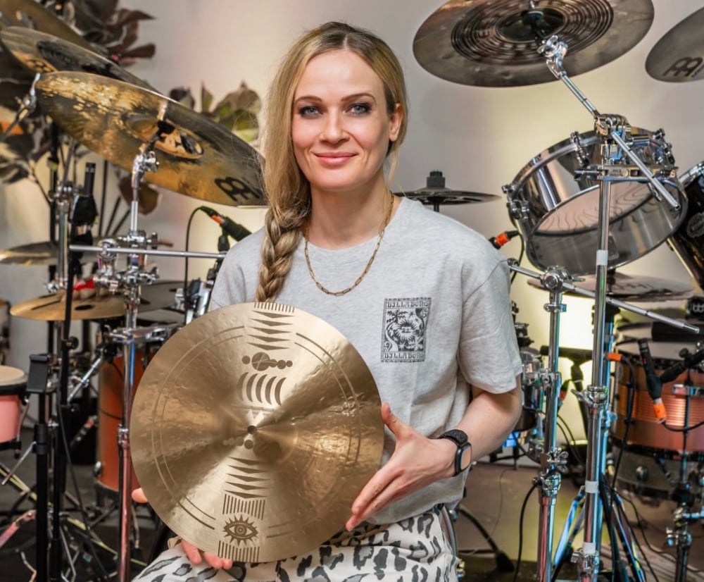 Anika Nilles holding her Meinl Artist Design ride, showing the artwork engraved into the bronze