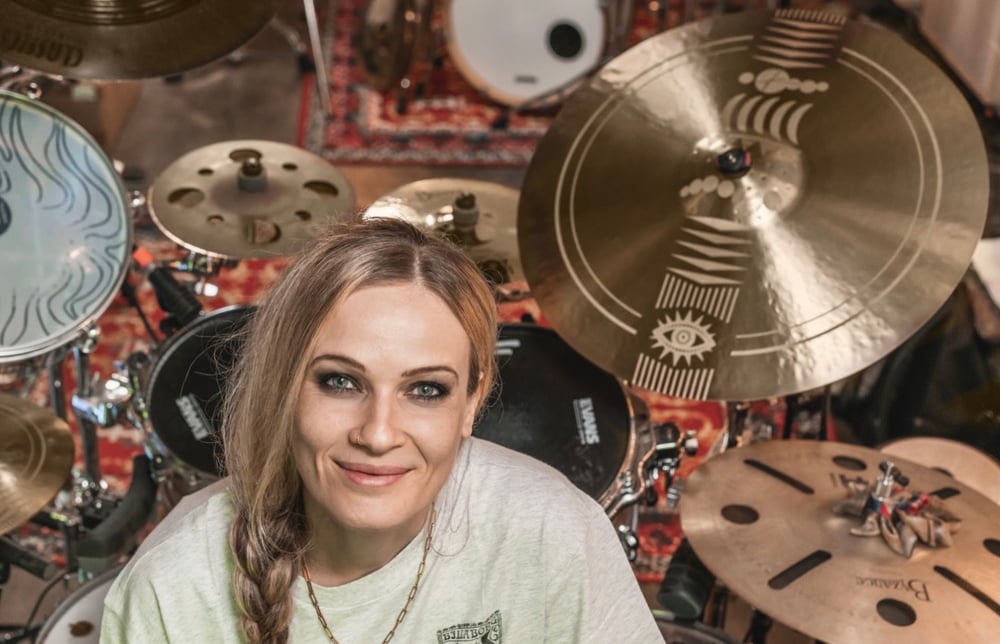 Anika Nilles behind her kit with the engraved Artist Design ride mounted to her right