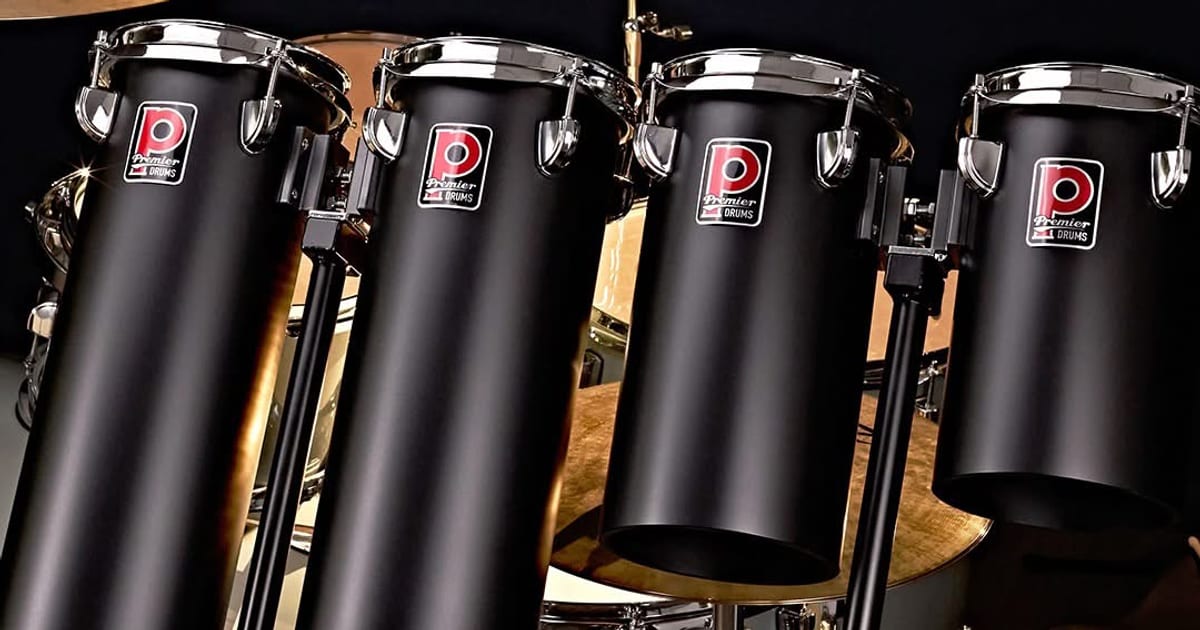 Four Premier Artist Octobans in matte black with chrome hoops and Premier badges, mounted in a row
