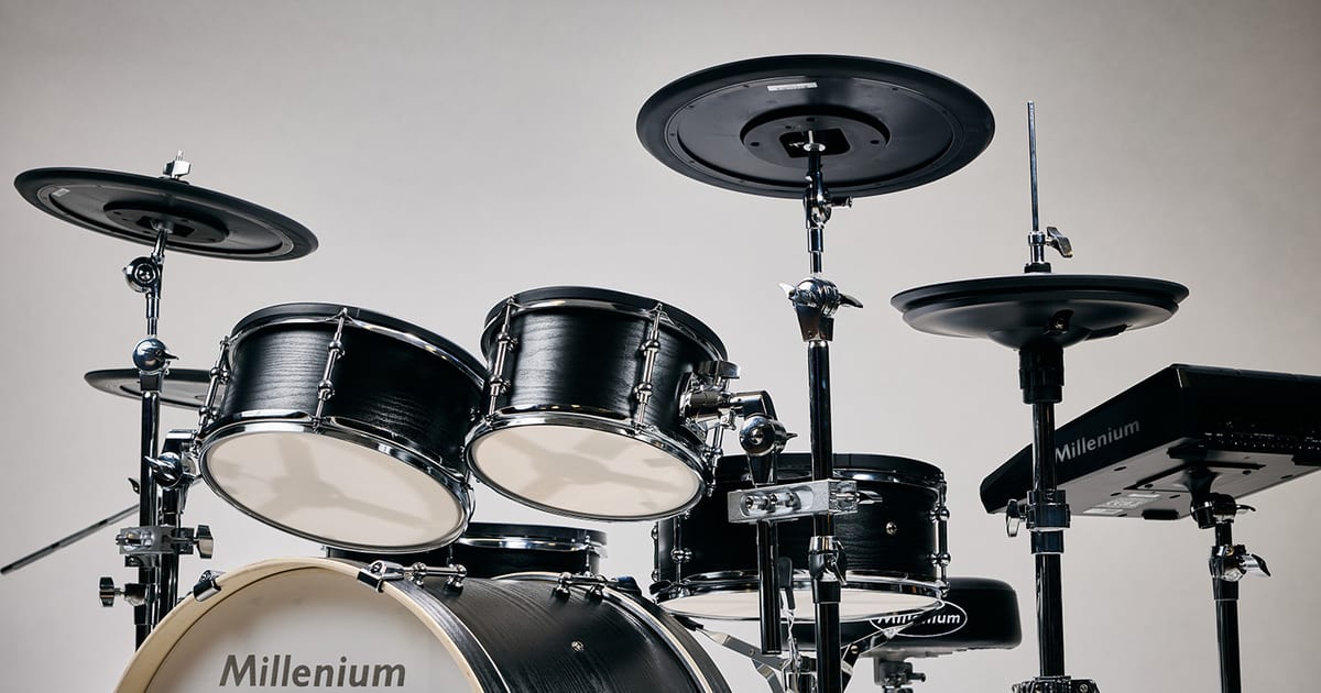 The Millenium MPS-1500 Hybrid-X electronic drum kit, showing its black wood-shelled drums with mesh heads and its cymbal pads