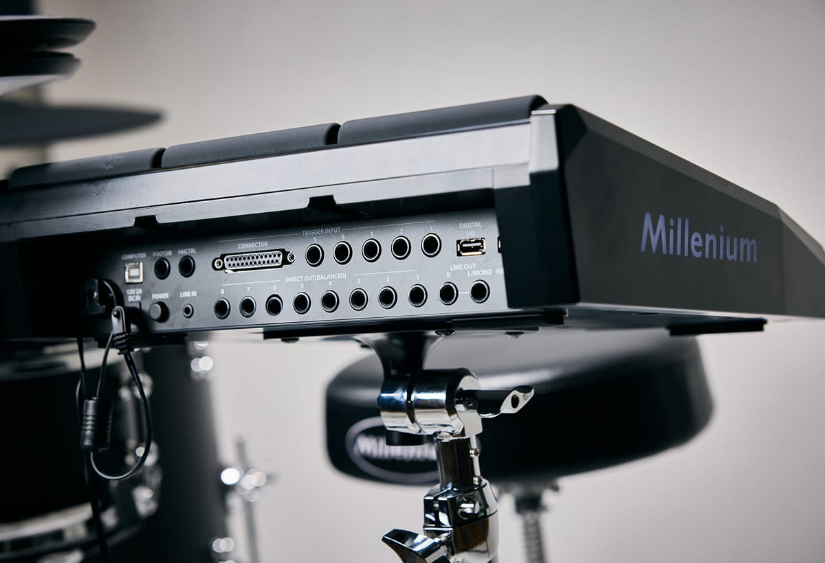 The rear panel of the Millenium MPS-1500 Hybrid-X module, showing five trigger inputs, eight balanced direct outputs, line and headphone outs, USB and a multi-pin connector