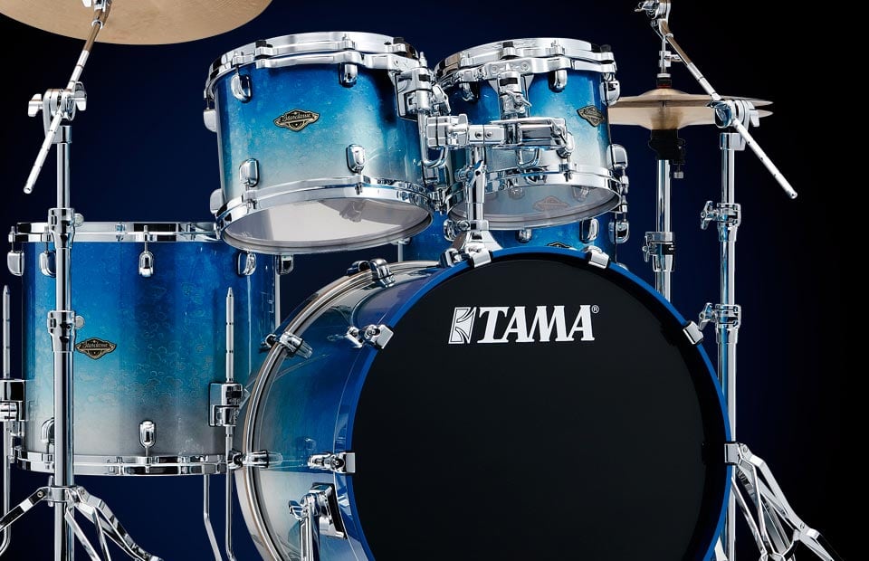A Tama Starclassic kit in a blue-to-silver burst finish, with chrome hardware and a black bass drum head