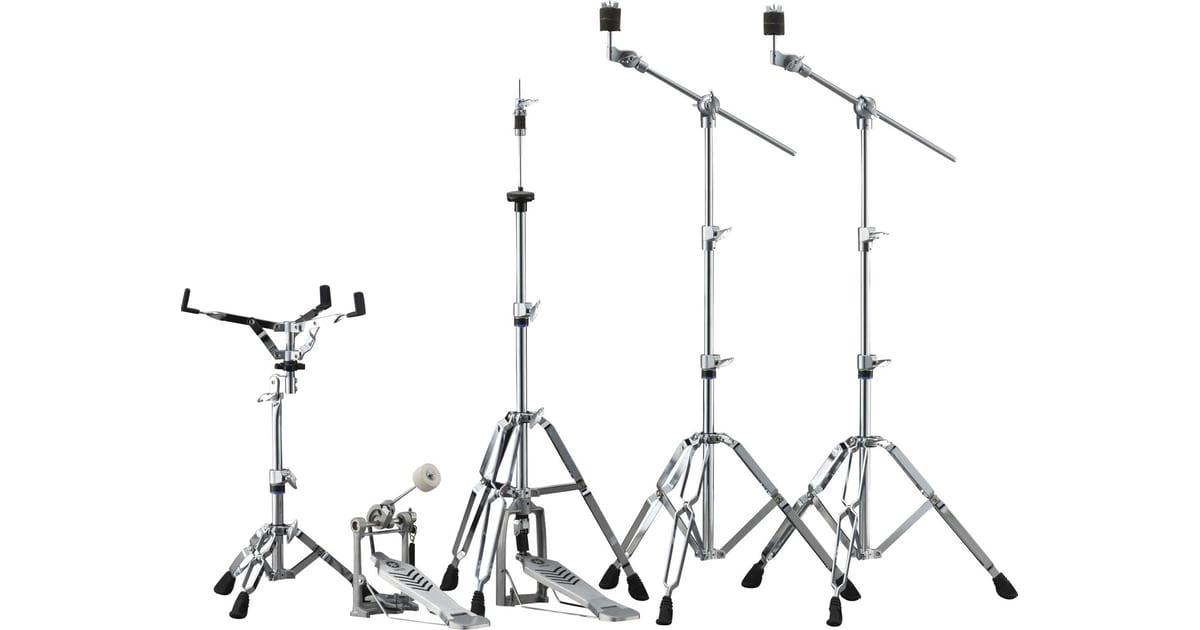 Yamaha's refreshed drum hardware — snare stand, bass drum pedal, hi-hat stand and two double-braced boom cymbal stands in chrome, with blue accent rings on the tubes