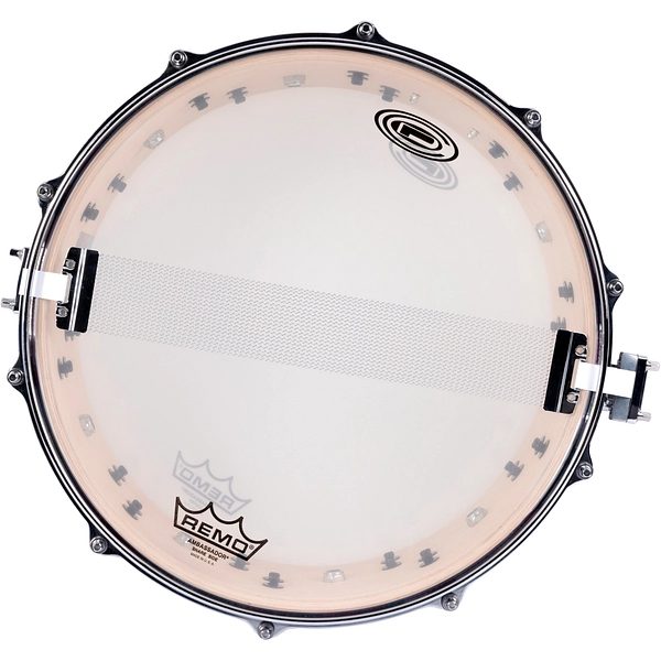 The underside of the OCDP John Otto snare, showing the snare wires, Remo Ambassador snare-side head and the sharktooth lugs through the clear head